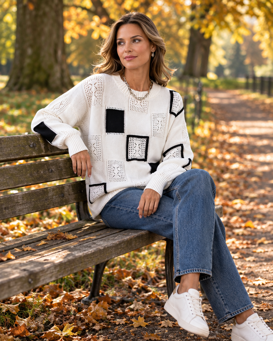 Relaxed round-neck knit sweater worn on a bench during an autumn park walk in the UK